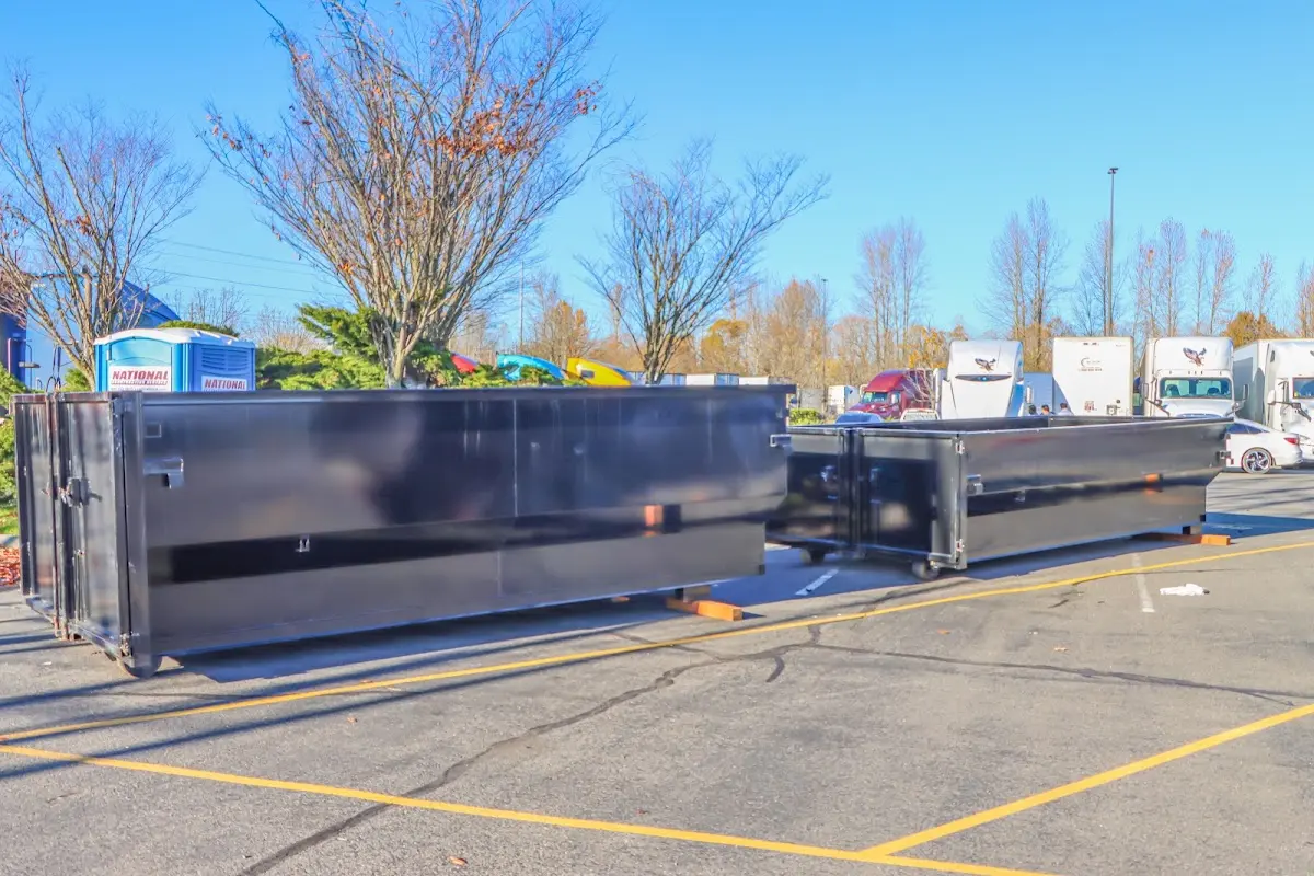 Professional dumpster rental service with roll-off container on residential driveway in Tobyhanna